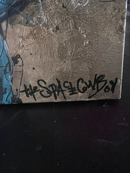Close-up of The Space Cowboy’s signature over the textured gold ground of Tie Grrr Luxe II.