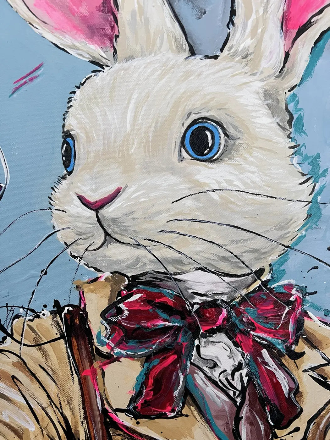 Close-up of the white rabbit’s blue eyes, painted fur and layered burgundy bow in Never too late -white coat II.