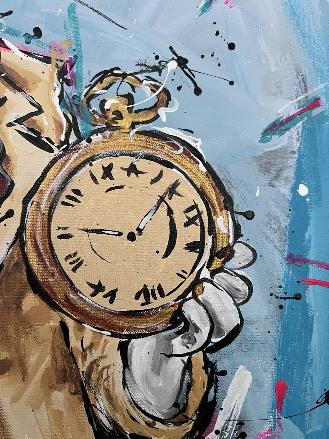 Close-up of the gold-coloured pocket watch held in the rabbit’s white-gloved paw.
