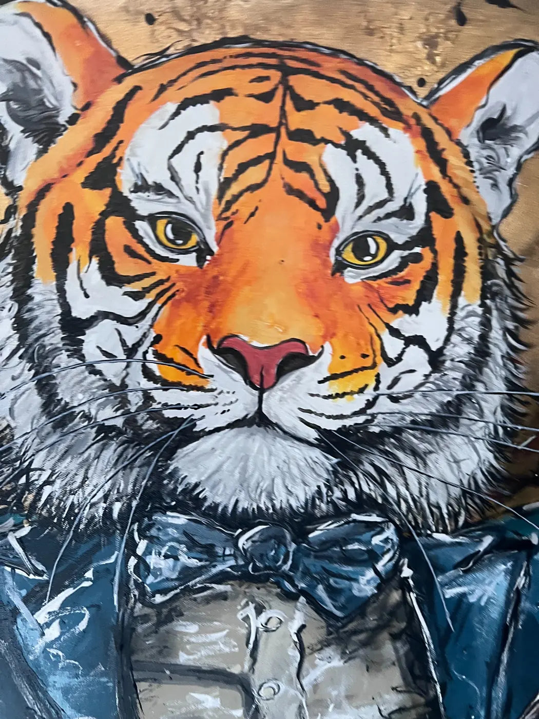 Close-up of the tiger’s face, golden eyes and blue bow tie in Tie Grrr Luxe II.