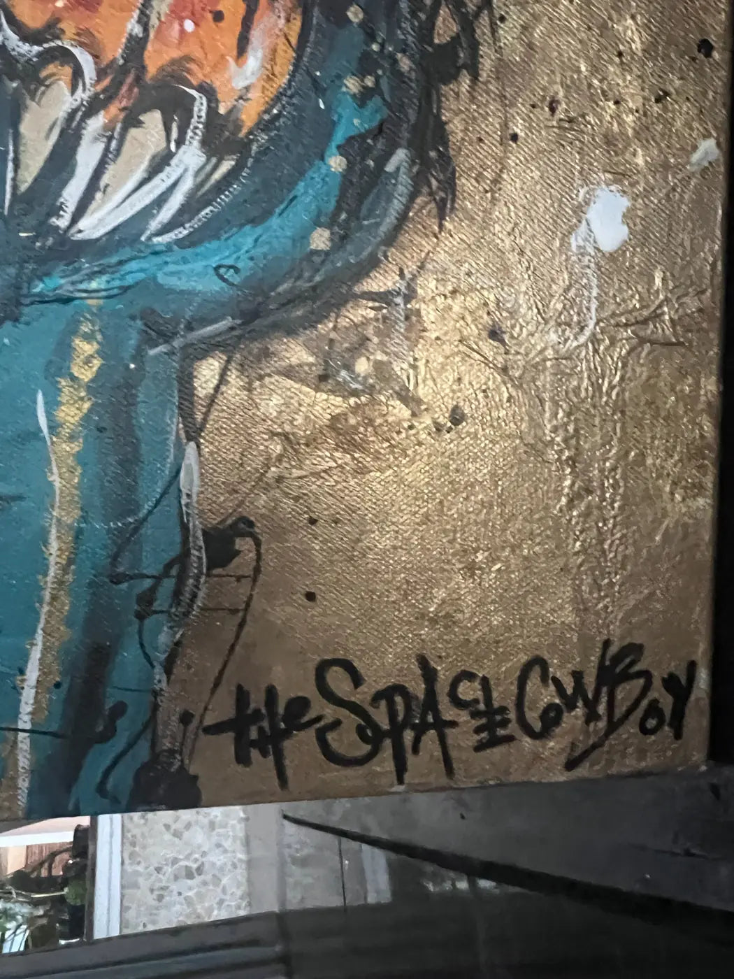 Detail of The Space Cowboy’s signature beside the tiger and textured gold ground in Tie Grrr Luxe II.